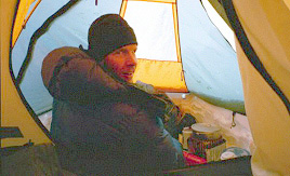 Jason cooking in the vestibule of the tent.