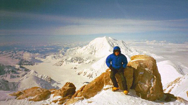  Josh sitting on some of the beautiful red granite rocks near the 17K foot camp.