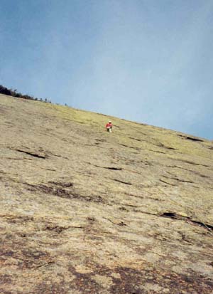 Mike at the first bolt on the first pitch of the Slide (5.7)